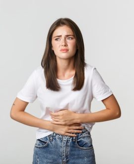 woman-having-stomach-ache-bending-with-hands-belly-discomfort-from-menstrual-cramps
